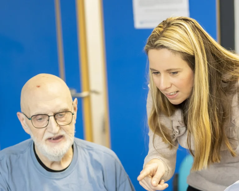 Woman helping older man