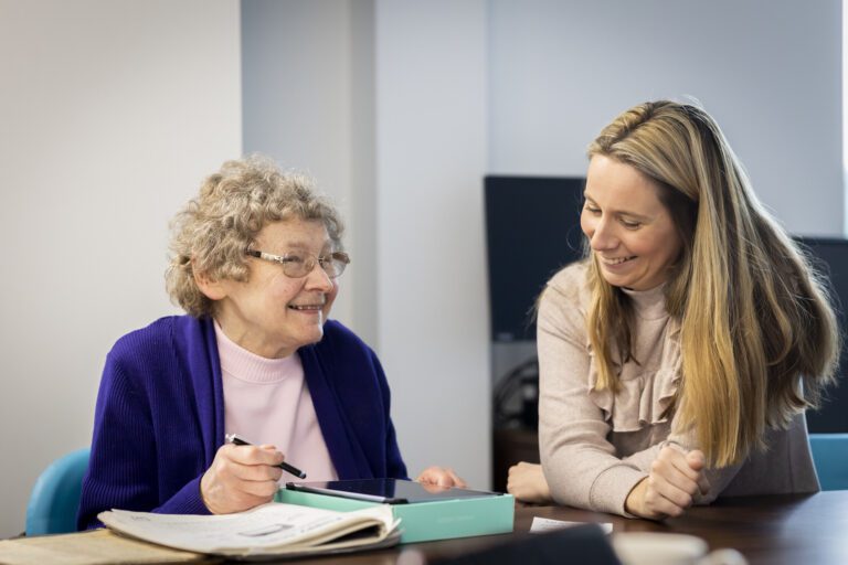 Woman helping older lady