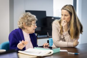 younger woman discussing with older lady