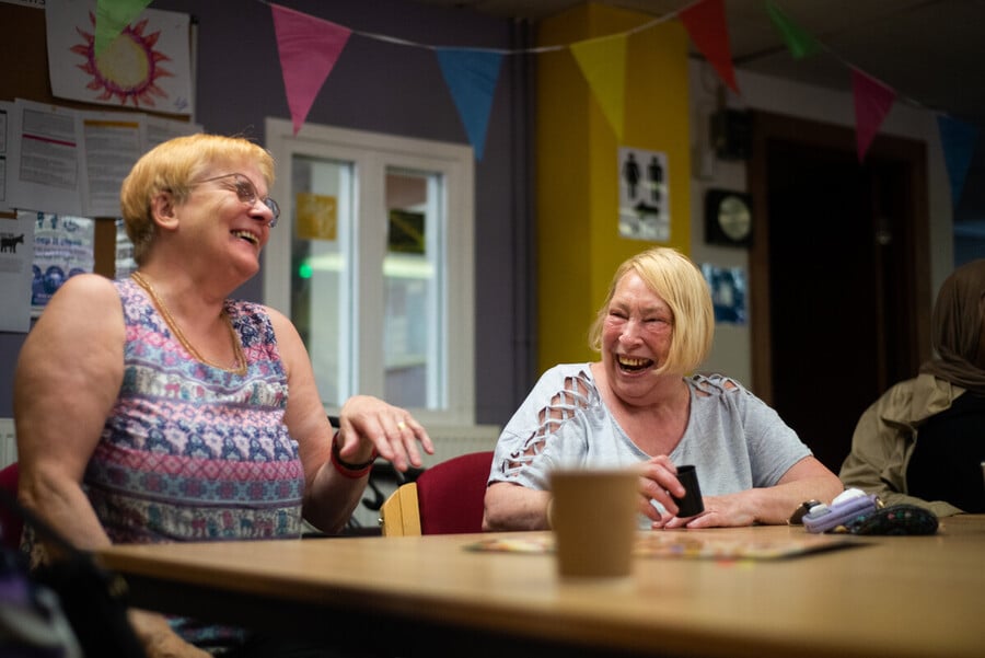 two ladies laughing with coffee